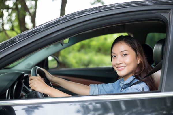 woman driver smiling from her car