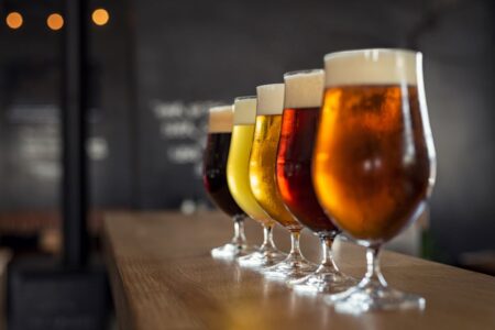 glasses of craft beer lined up on a bar