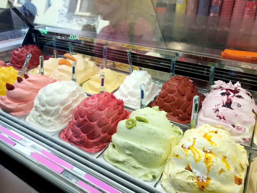 Many flavors of gelato in display case 