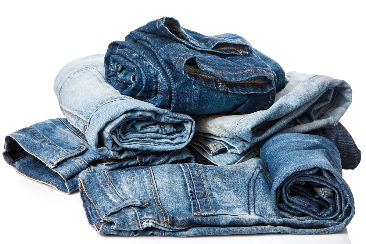 a pile of blue jeans denim clothing