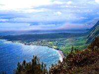 Molokai’s Kalaupapa Peninsula - a remote flatland at the base of cliffs rising to 2,000 feet (600m). Photo by John Richard Stephen.